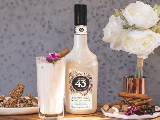 Licor 43 Horchata The Sweet Vegan 43 in tall glass with licor 43 horchata bottle and set dressing