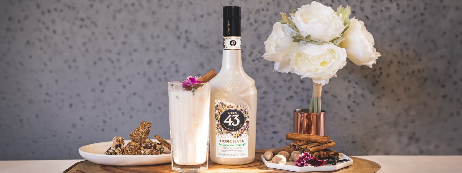Licor 43 Horchata The Sweet Vegan 43 in tall glass with licor 43 horchata bottle and set dressing
