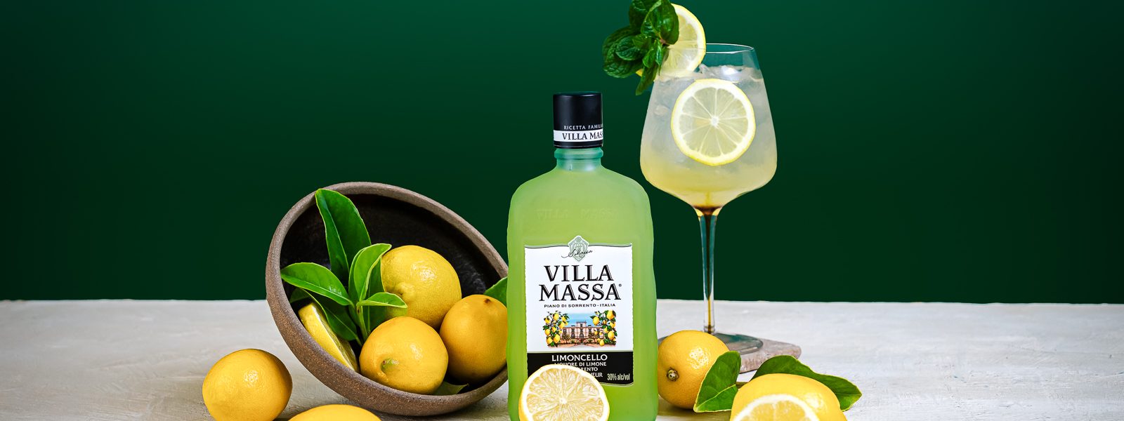Villa Massa Limoncello Spritz cocktail with Villa Massa Limoncello bottle and lemons